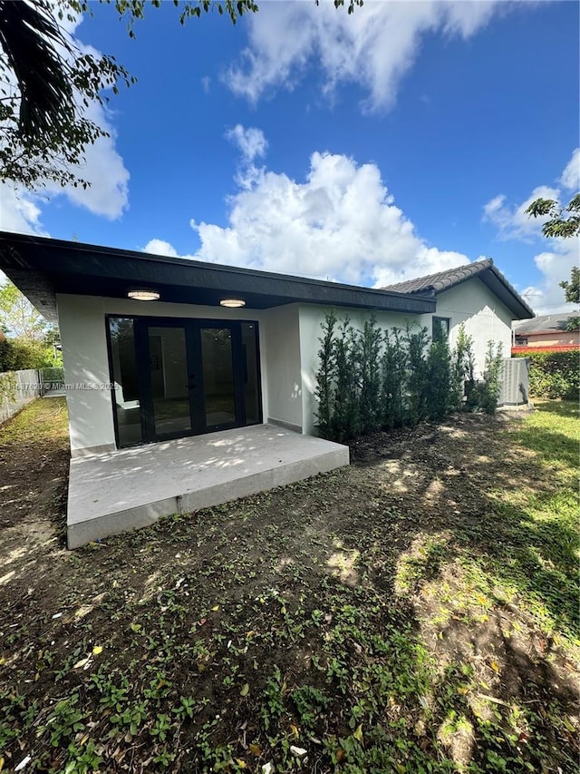 rear view of property featuring a patio area and french doors