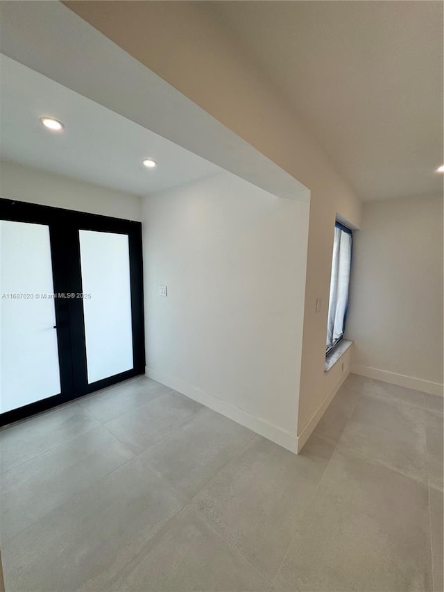 unfurnished room featuring french doors