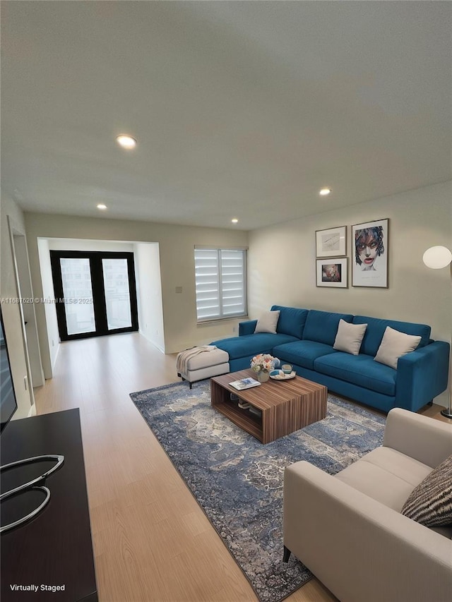 living room with french doors and light hardwood / wood-style flooring