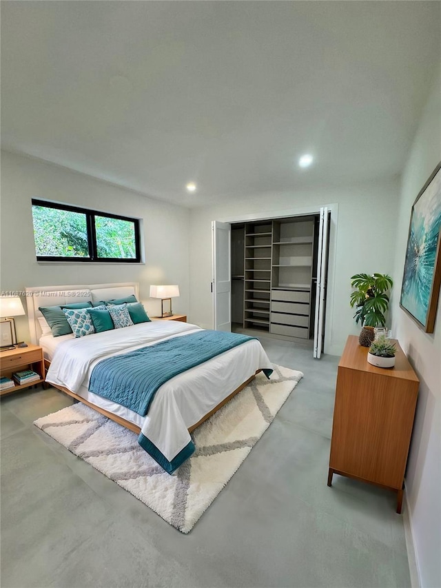 bedroom featuring concrete floors and recessed lighting