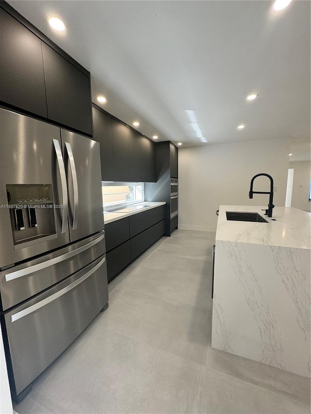 kitchen with stainless steel appliances, a kitchen island with sink, and sink