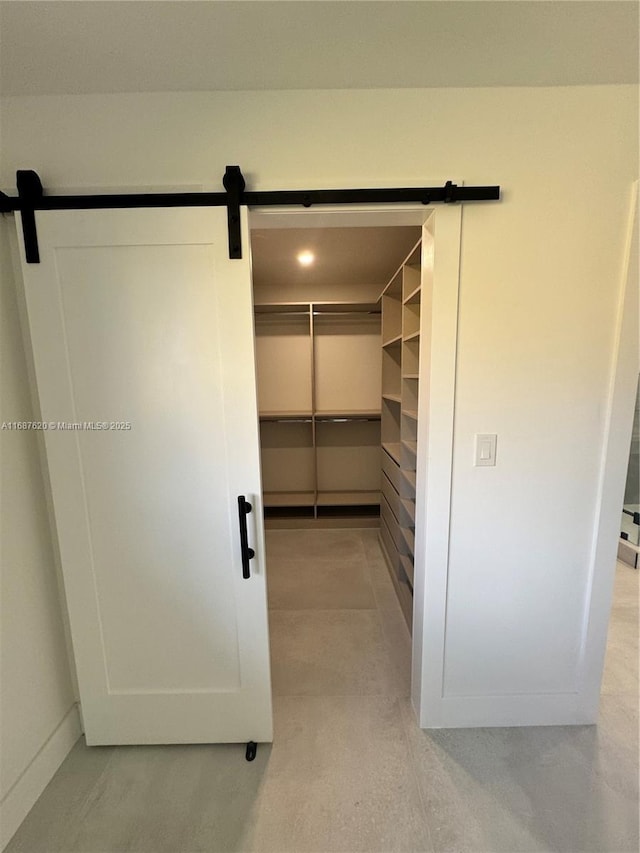 walk in closet with a barn door