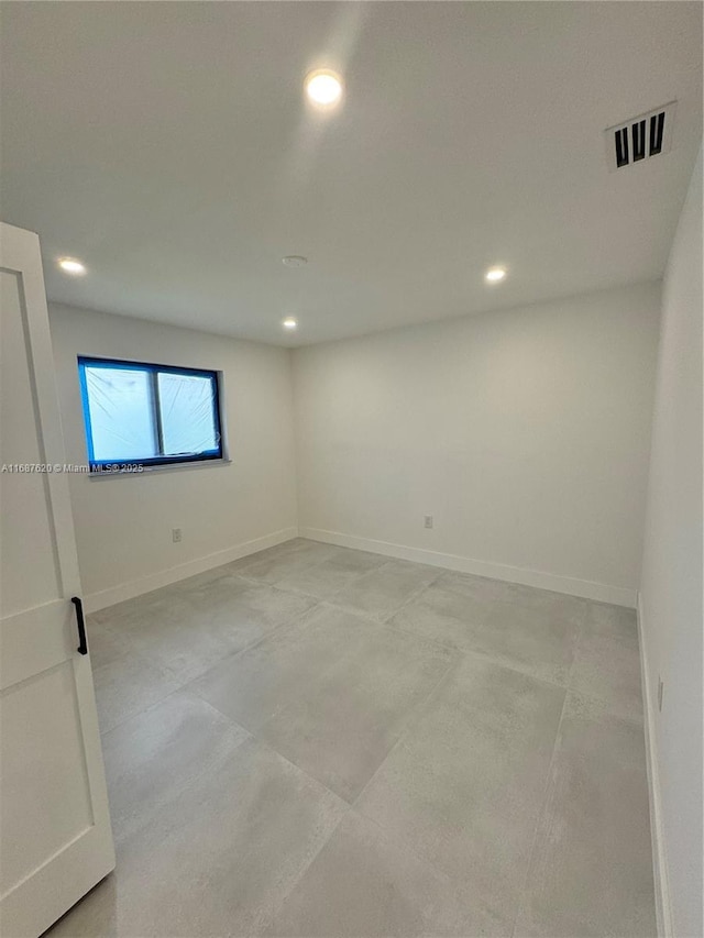 spare room with recessed lighting, baseboards, and visible vents