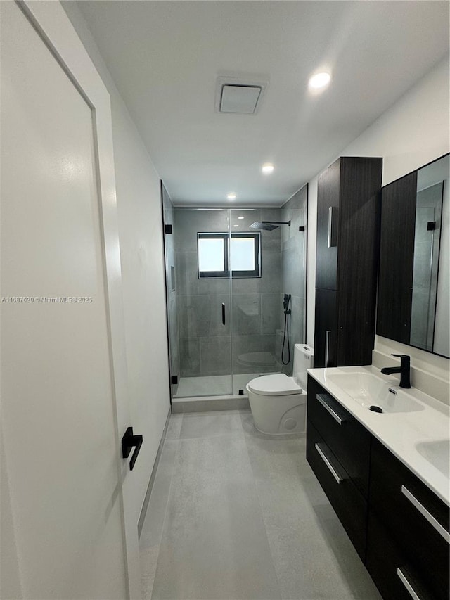 bathroom with vanity, toilet, and an enclosed shower