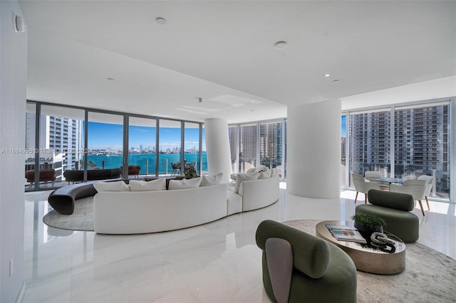 living room with a wall of windows and a water view