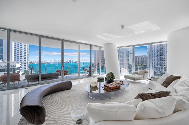 living room featuring a water view and floor to ceiling windows