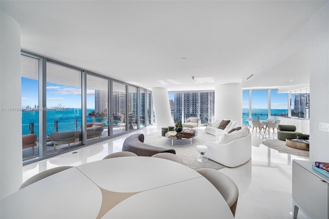 living room featuring expansive windows and a water view