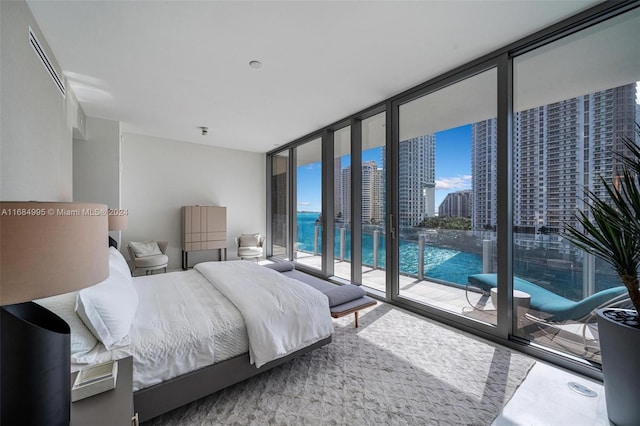 bedroom featuring expansive windows and access to exterior