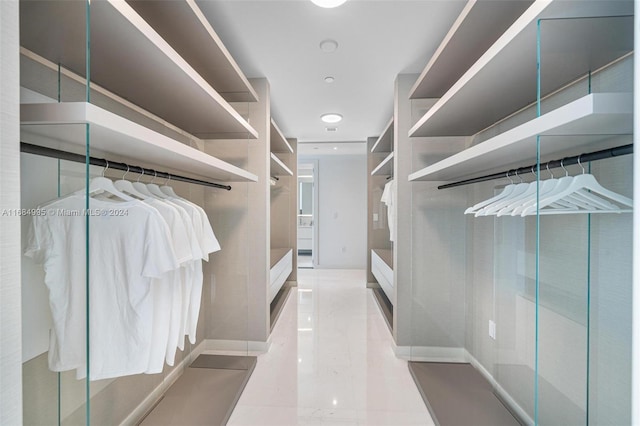 walk in closet with light tile patterned floors