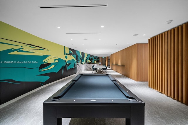 rec room with pool table and wood walls