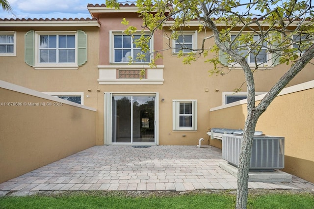 back of house featuring central air condition unit and a patio area