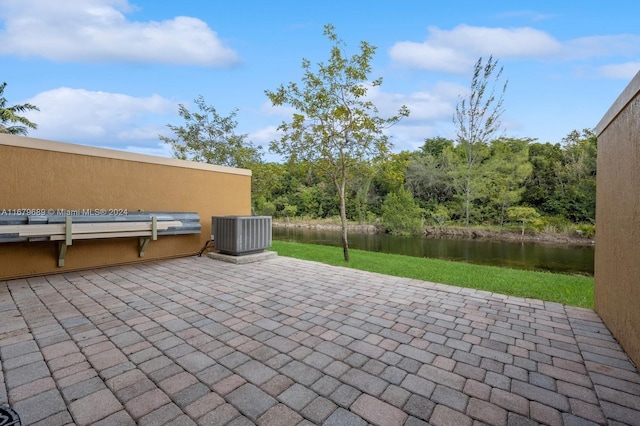 view of patio / terrace with a water view and central AC unit