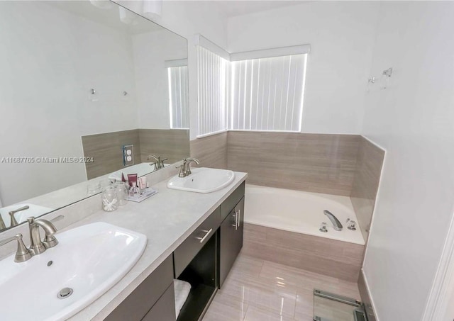 bathroom featuring vanity and a tub to relax in