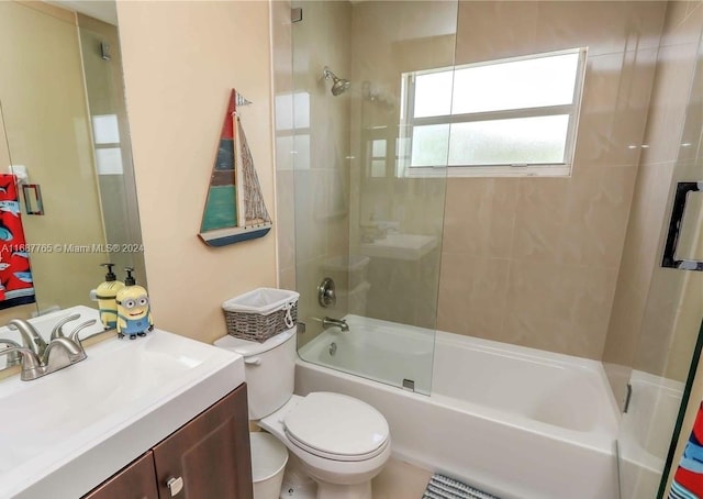 full bathroom with vanity, toilet, and bath / shower combo with glass door