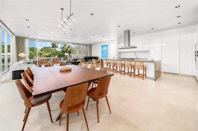 tiled dining area featuring floor to ceiling windows