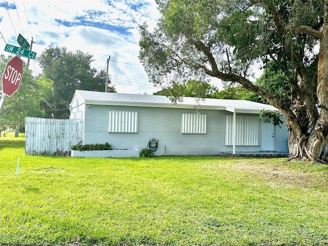 back of house with a lawn