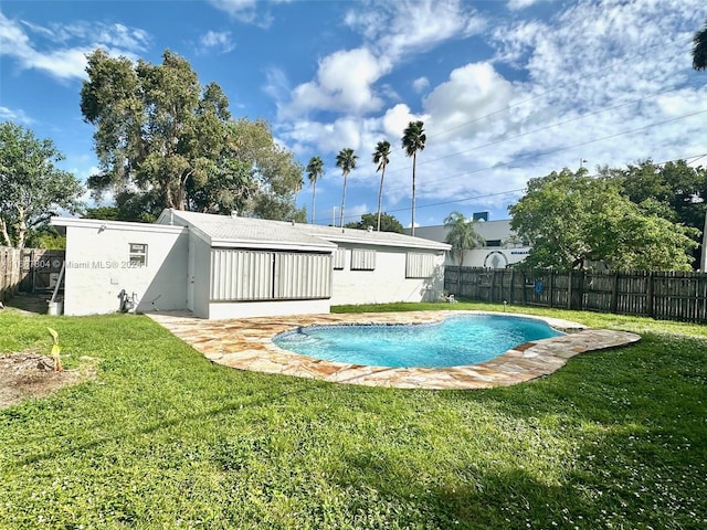 view of swimming pool featuring a yard and a patio