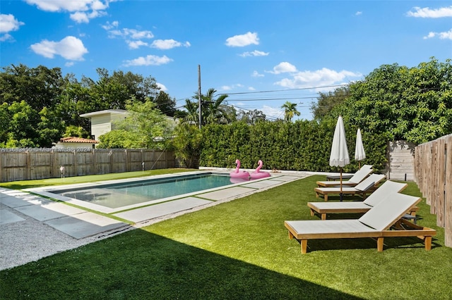 view of pool featuring a yard