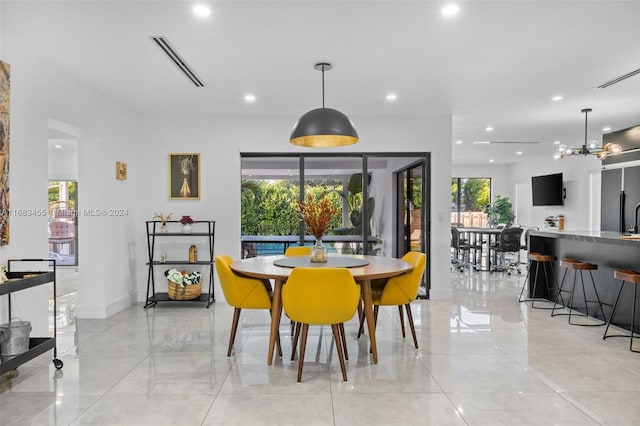 dining space with an inviting chandelier