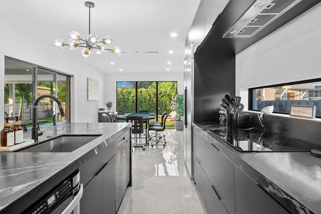 kitchen with black electric cooktop, dishwasher, hanging light fixtures, sink, and a notable chandelier