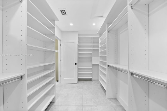 walk in closet with light tile patterned floors