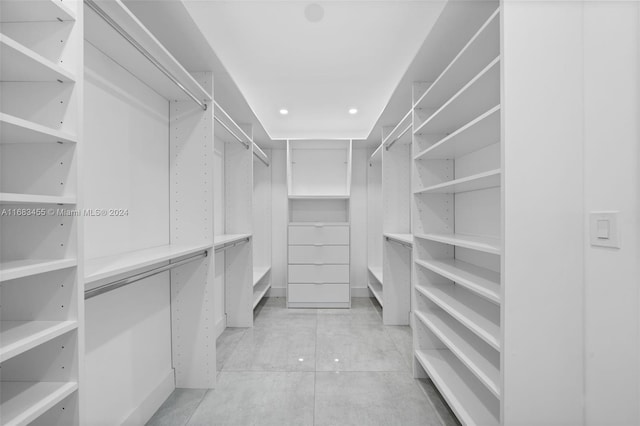 spacious closet featuring light tile patterned floors