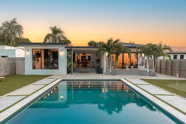 exterior space featuring a fenced in pool and a patio