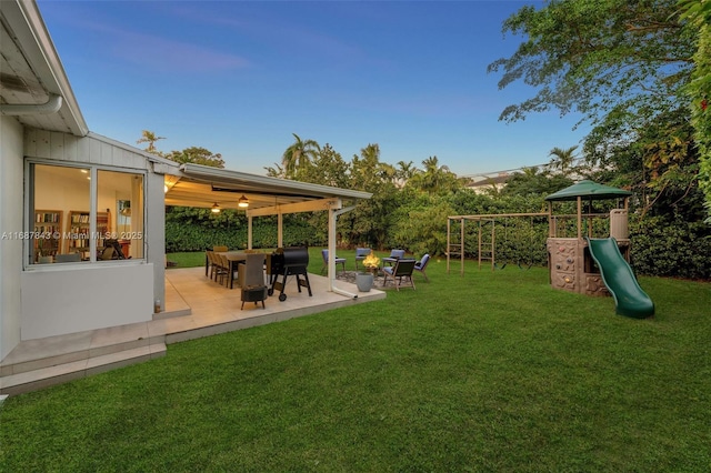 view of yard featuring a patio and a playground