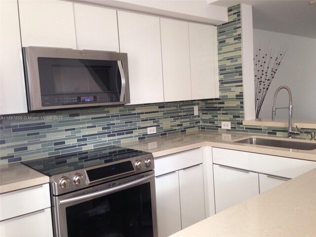 kitchen featuring stainless steel appliances and backsplash