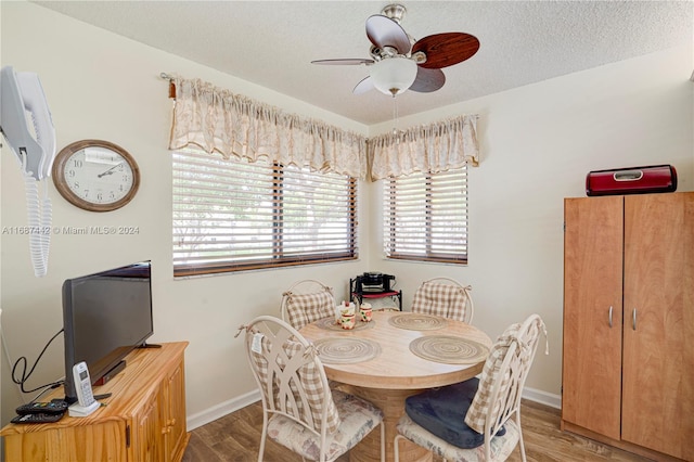 dining area featuring a textured ceiling, hardwood / wood-style flooring, and ceiling fan