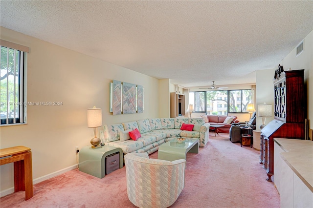 carpeted living room featuring a wealth of natural light, a textured ceiling, and ceiling fan