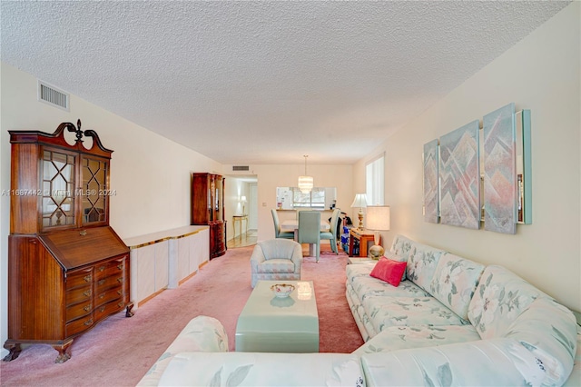 carpeted living room featuring a textured ceiling