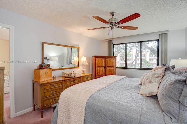 bedroom featuring carpet, a textured ceiling, and ceiling fan