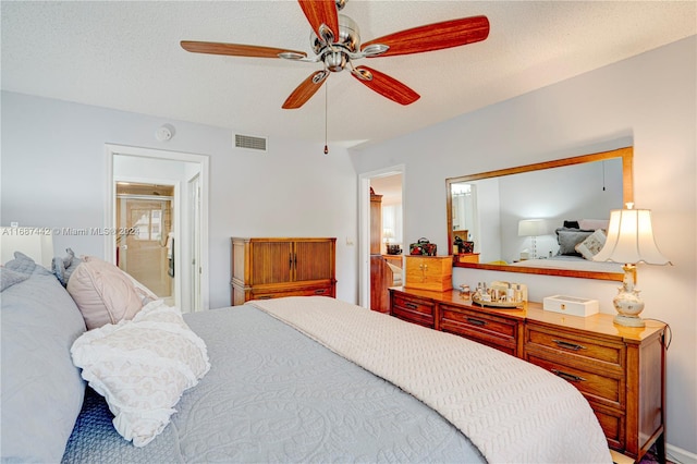 bedroom featuring connected bathroom, a textured ceiling, and ceiling fan