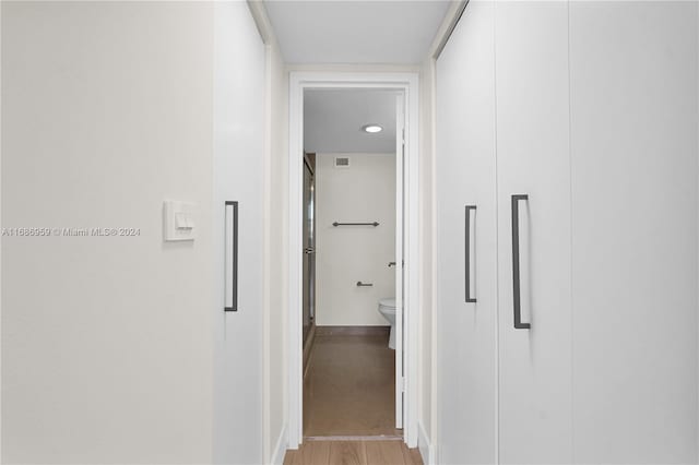 hallway with light hardwood / wood-style floors