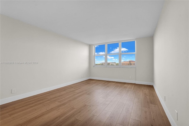 spare room with light hardwood / wood-style floors