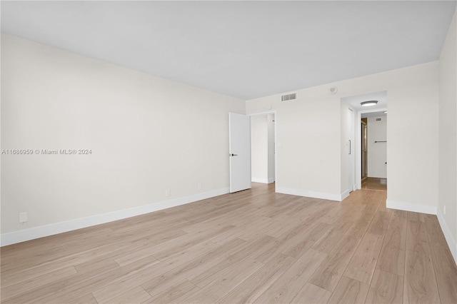 empty room with light hardwood / wood-style flooring