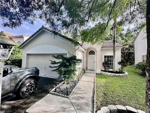 view of front of home featuring a front lawn and a garage