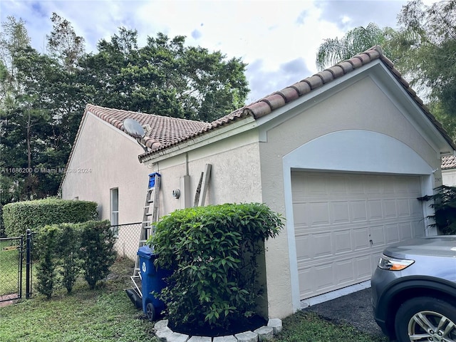 view of side of home with a garage