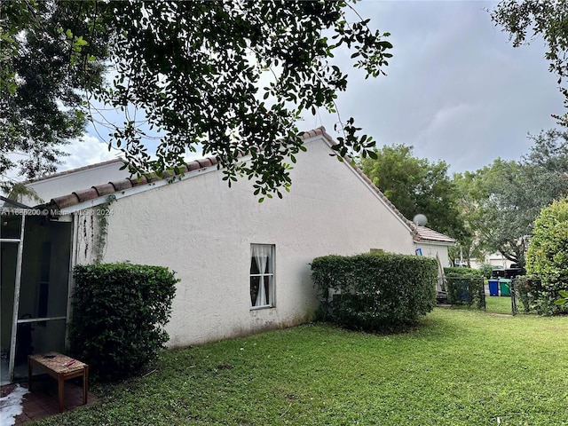 view of property exterior with a lawn