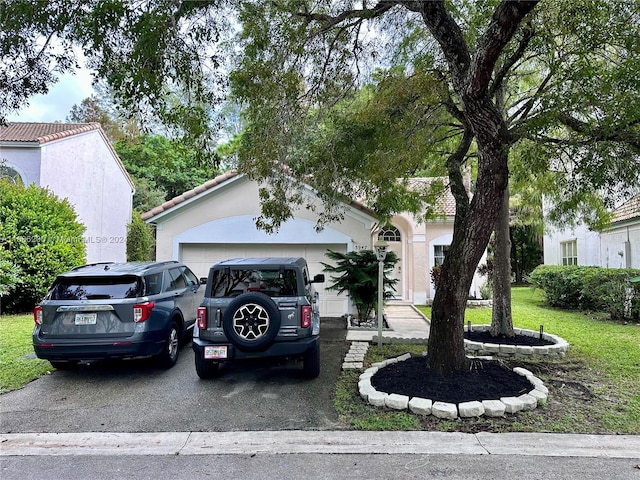 view of front of property with a front yard and a garage