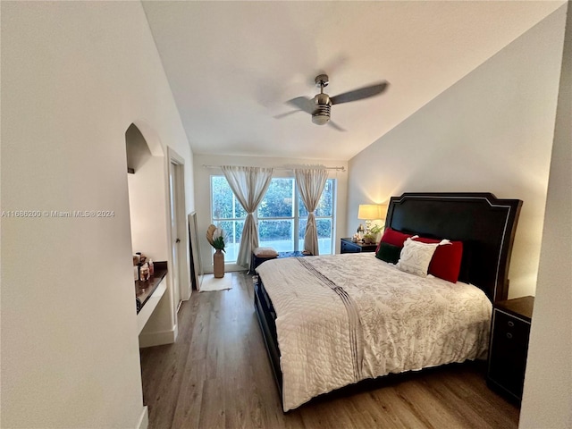 bedroom featuring dark hardwood / wood-style floors, access to exterior, and ceiling fan