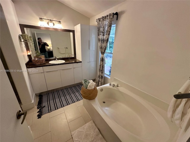 bathroom with vanity, a bathtub, and tile patterned floors