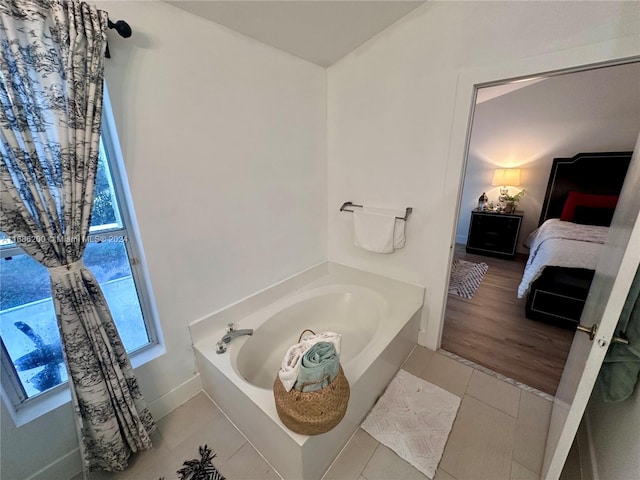 bathroom with a bathtub and wood-type flooring