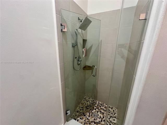 bathroom featuring a shower with door