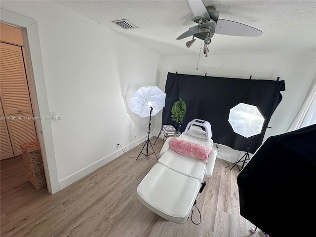 interior space featuring a textured ceiling, light hardwood / wood-style floors, and ceiling fan