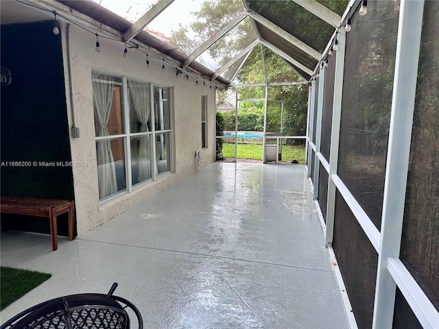 unfurnished sunroom with lofted ceiling