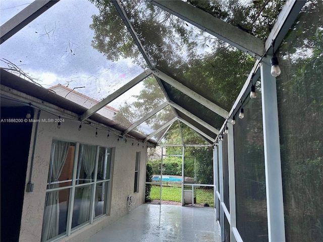 unfurnished sunroom with vaulted ceiling