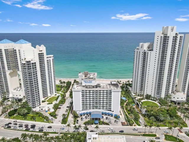 drone / aerial view with a water view and a beach view