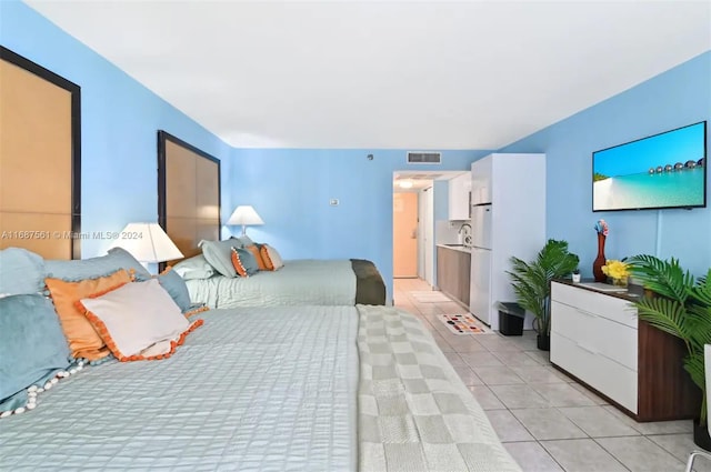 tiled bedroom featuring white refrigerator